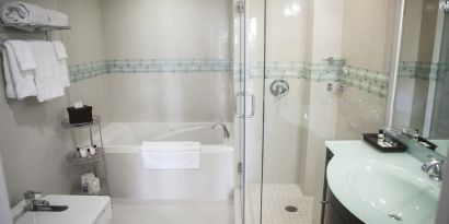 Guest bathroom with shower and tub at The Mutiny Hotel.