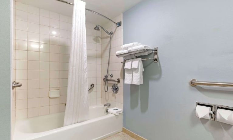 Guest bathroom with shower and tub at Best Western Hartford Hotel & Suites.