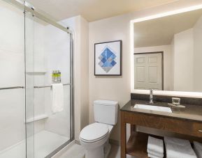 Guest bathroom with shower at Candlewood Suites Meridian.