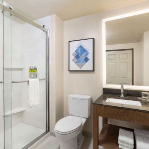 Guest bathroom with shower at Candlewood Suites Meridian.