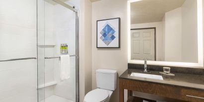 Guest bathroom with shower at Candlewood Suites Meridian.