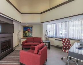 Hotel lobby with fireplace and worskpace with computer and printer at Comfort Inn Corner Brook.