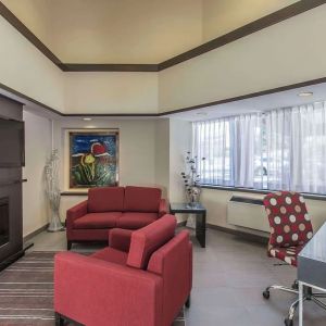 Hotel lobby with fireplace and worskpace with computer and printer at Comfort Inn Corner Brook.