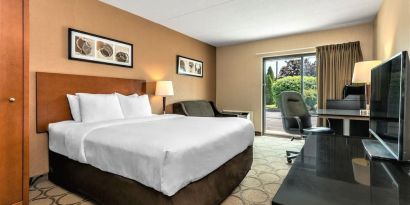 Day use room with TV, sofa, work desk and private bathroom at Comfort Inn Winnipeg II South.