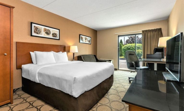 Day use room with TV, sofa, work desk and private bathroom at Comfort Inn Winnipeg II South.