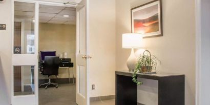 Business center with computer, printer and ergonomic chair at Comfort Inn Winnipeg II South.