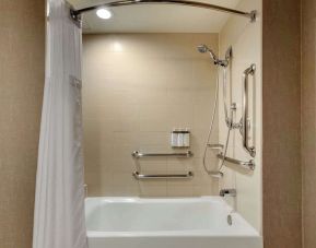 Guest bathroom with shower and tub at Cambria Suites Denver Airport.