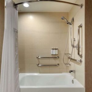 Guest bathroom with shower and tub at Cambria Suites Denver Airport.