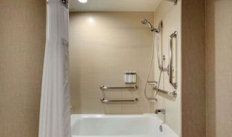 Guest bathroom with shower and tub at Cambria Suites Denver Airport.