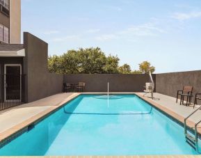 Refreshing outdoor pool at La Quinta Inn & Suites - North Stone Oak.