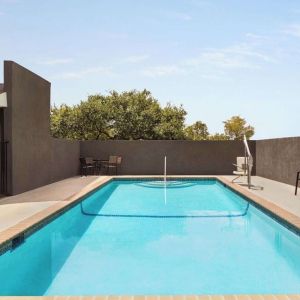 Refreshing outdoor pool at La Quinta Inn & Suites - North Stone Oak.