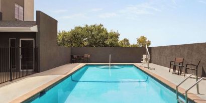 Refreshing outdoor pool at La Quinta Inn & Suites - North Stone Oak.