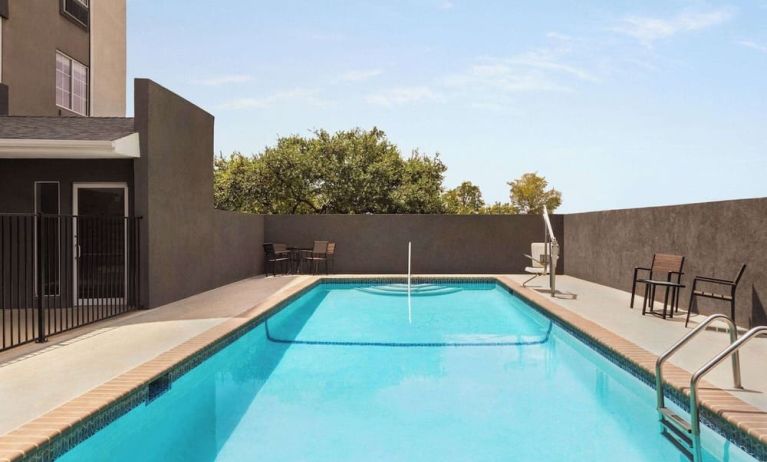 Refreshing outdoor pool at La Quinta Inn & Suites - North Stone Oak.