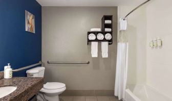 Guest bathroom with shower and tub at La Quinta Inn & Suites - North Stone Oak.