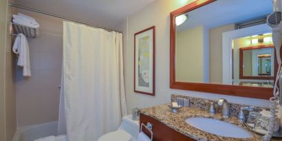 Guest bathroom with shower and tub at San Carlos Hotel.