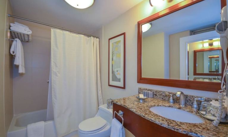 Guest bathroom with shower and tub at San Carlos Hotel.