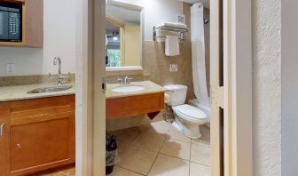 Guest bathroom with shower and tub at Rodeway Inn & Suites Fort Lauderdale Airport & Cruise Port.