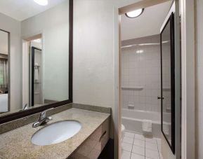 Guest bathroom with shower and tub at Best Western Woodbury Inn.