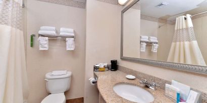 Guest bathroom with shower at Hampton Inn Deer Park.