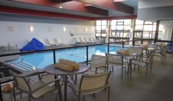 Tables and chairs available beside pool at DoubleTree By Hilton Westborough.