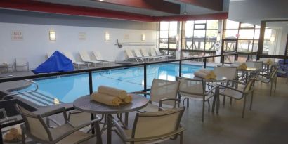 Tables and chairs available beside pool at DoubleTree By Hilton Westborough.