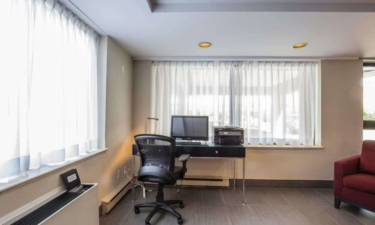 Business center with computer, printer and ergonomic chair at Comfort Inn Pickering.