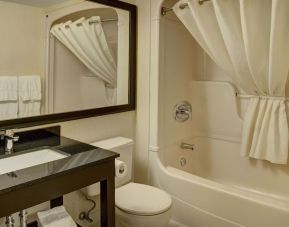 Guest bathroom with tub at Comfort Inn Pickering.