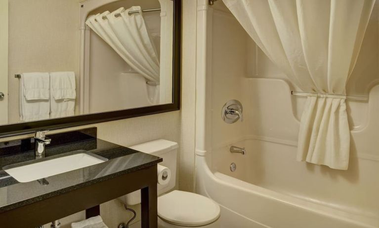 Guest bathroom with tub at Comfort Inn Pickering.