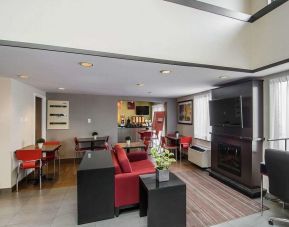 Lobby lounge with TV screen and fireplace at Comfort Inn Prince Albert.