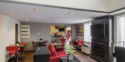 Lobby lounge with TV screen and fireplace at Comfort Inn Prince Albert.