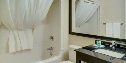 Guest bathroom with tub and free toiletries at Comfort Inn Prince Albert.