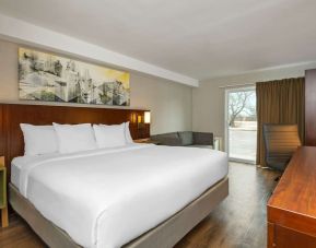 Day use room with TV, sofa, work desk and private bathroom at Comfort Inn Ottawa East.