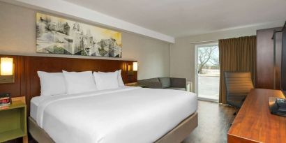 Day use room with TV, sofa, work desk and private bathroom at Comfort Inn Ottawa East.