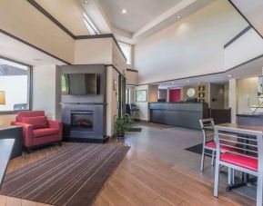 Hotel lobby with lounge area and fireplace at Comfort Inn Cobourg.