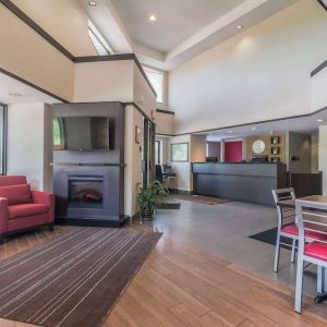 Hotel lobby with lounge area and fireplace at Comfort Inn Cobourg.