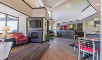 Hotel lobby with lounge area and fireplace at Comfort Inn Cobourg.