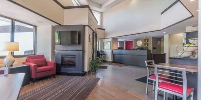 Hotel lobby with lounge area and fireplace at Comfort Inn Cobourg.