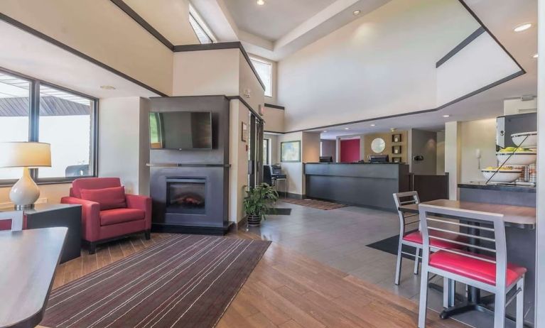 Hotel lobby with lounge area and fireplace at Comfort Inn Cobourg.