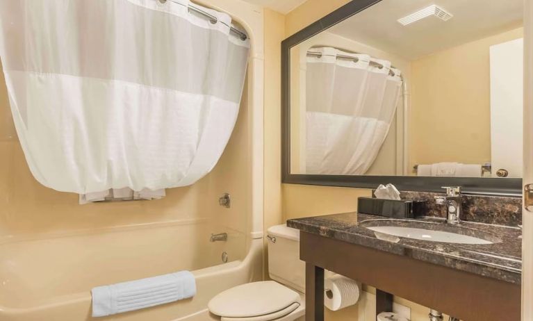 Guest bathroom with tub and free toiletries at Comfort Inn Cobourg.