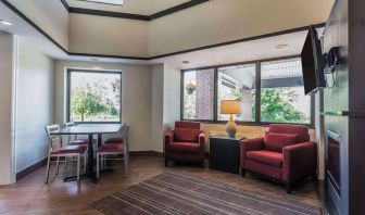 Lobby lounge with TV screen and fireplace at Comfort Inn Cobourg.