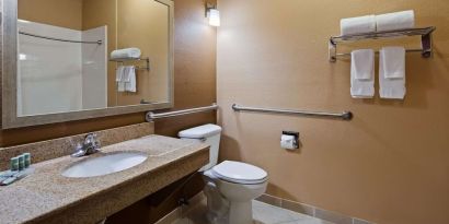 Guest bathroom with shower at Best Western Granbury Inn & Suites.