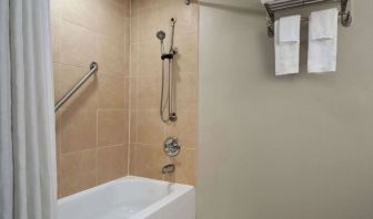 Guest bathroom with shower and tub at Wyndham Garden Pittsburgh Airport.