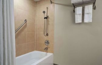 Guest bathroom with shower and tub at Wyndham Garden Pittsburgh Airport.