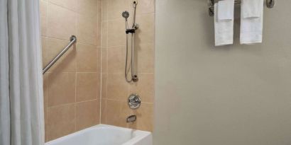 Guest bathroom with shower and tub at Wyndham Garden Pittsburgh Airport.