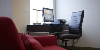 Lobby workspace with computer, printer and ergonomic chair at Comfort Inn Orillia.