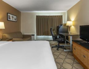 Day use room with TV, work desk, sofa and private bathroom at Comfort Inn Orillia.