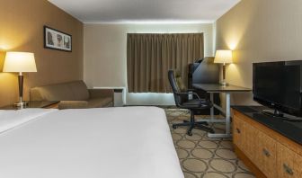 Day use room with TV, work desk, sofa and private bathroom at Comfort Inn Orillia.