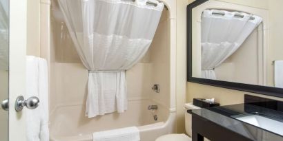 Guest bathroom with tub at Comfort Inn Orillia.