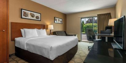 Standard day use room with TV, work desk, sofa and private bathroom at Comfort Inn New Glasgow.