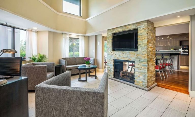 Lobby lounge with TV screen and fireplace at Comfort Inn Newmarket.